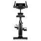 Black upright stationary exercise bike with digital console display, curved handlebars, and foot pedals on white background