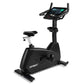 Spirit CU800ENT upright exercise bike with black frame, white seat, digital console with dual handles, and entertainment tabl