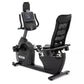 Spirit XBR95 black recumbent exercise bike with digital console, padded seat, and footrest on white background