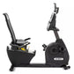 Black Spirit recumbent exercise bike with padded seat, backrest, handlebars, and device holder, on white background