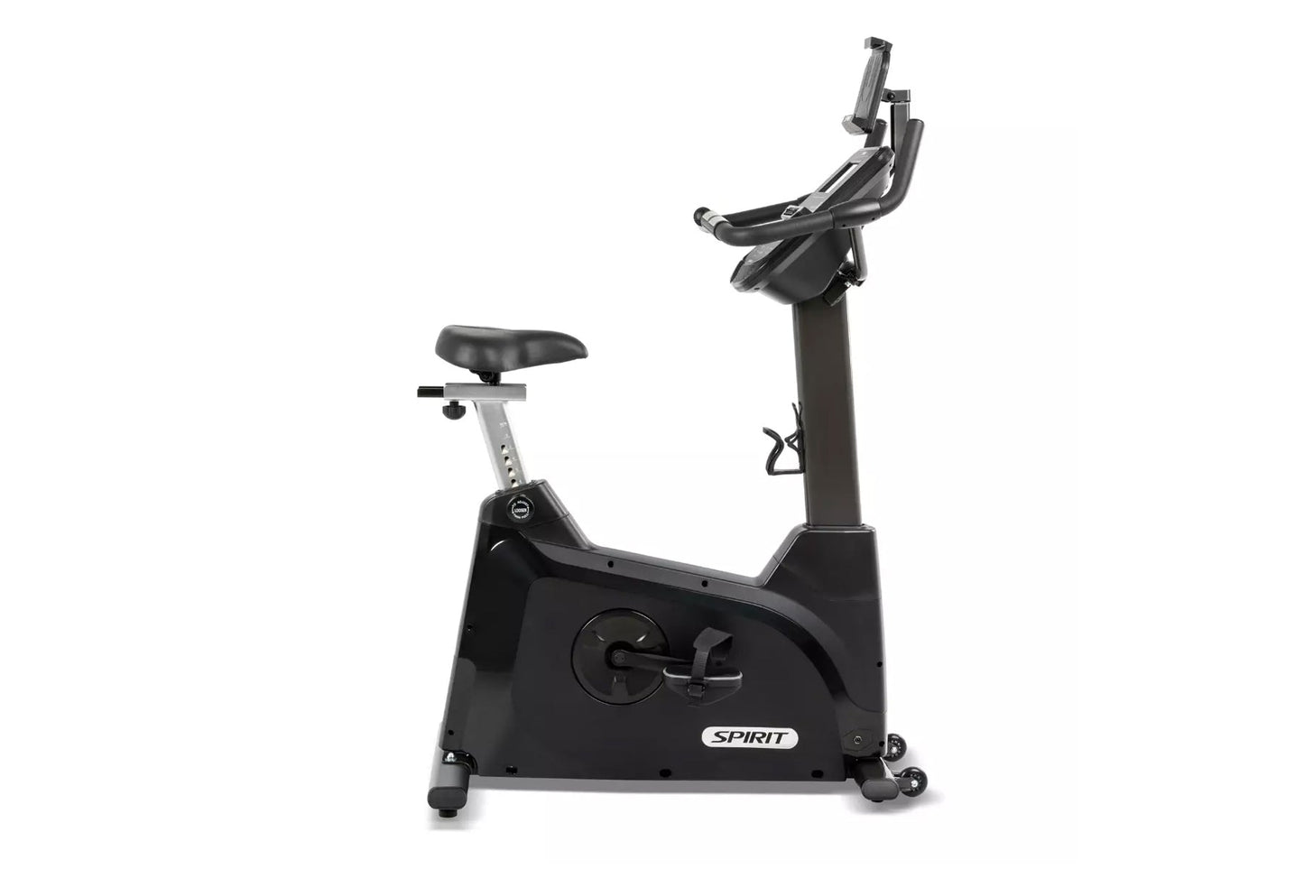 Black and gray Spirit upright stationary exercise bike with padded seat, adjustable handlebars, and digital console on white 