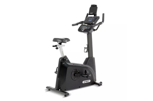 Spirit XBU55 upright exercise bike with black frame, digital console display, padded seat, and handlebars on white background