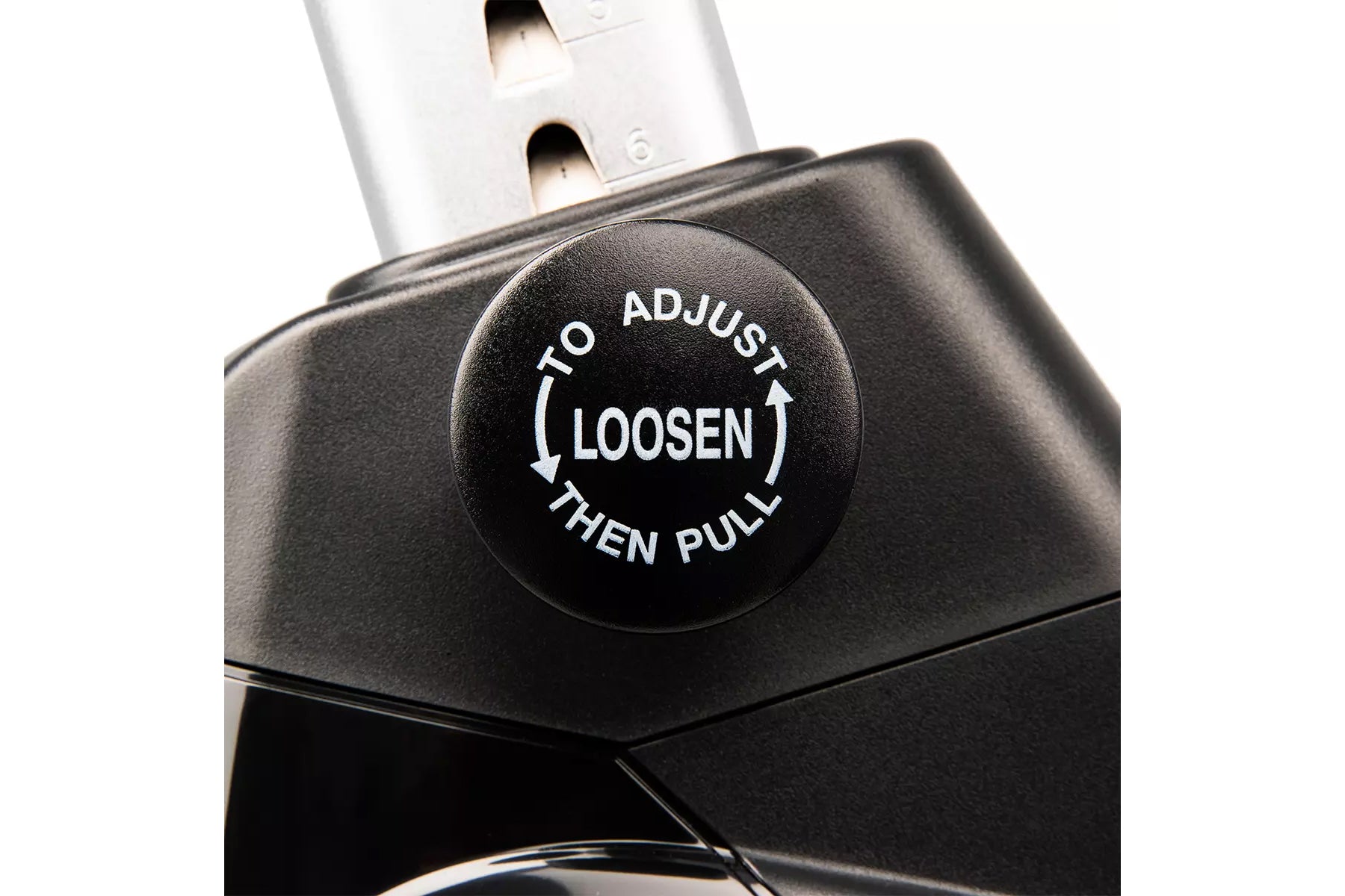 Black adjustment knob on upright exercise bike with white text reading "To Adjust Loosen Then Pull