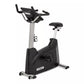 Spirit XBU55ENT upright exercise bike with black base, silver pole, black padded seat, and digital console display on white b
