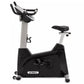 Spirit XBU55ENT upright exercise bike with black base, silver frame, padded black seat, and digital console on white backgrou
