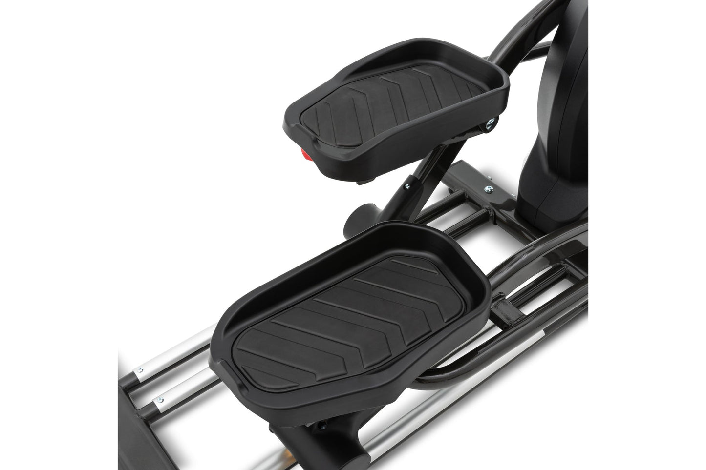 Black elliptical machine with textured foot pedals and upper body handles on silver frame, detail view