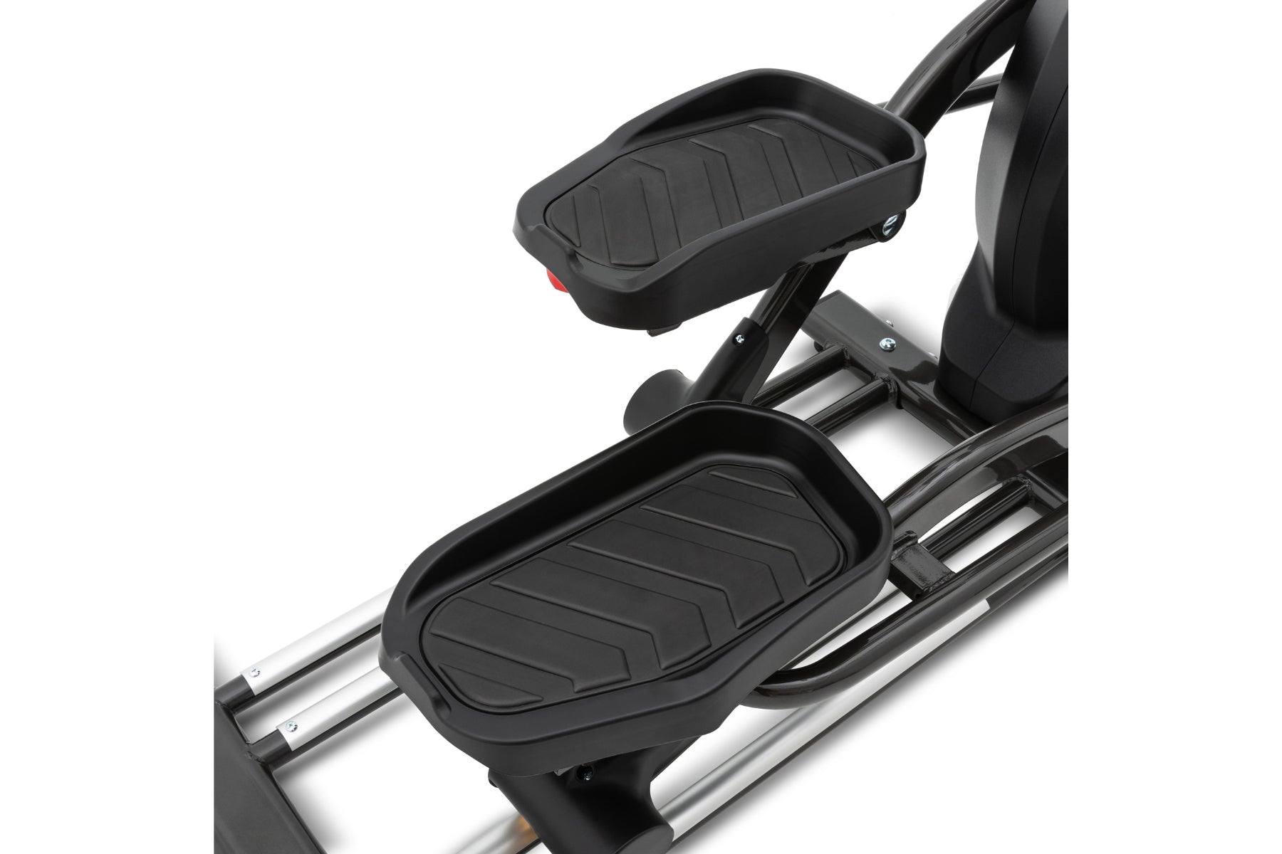 Black elliptical machine with textured foot pedals and upper body handles on silver frame, detail view