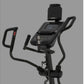 Spirit XE395 black elliptical machine with digital display console and dual handles on gray background
