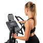 Woman using black Spirit XE795 elliptical machine with digital display, shown in side profile against white background