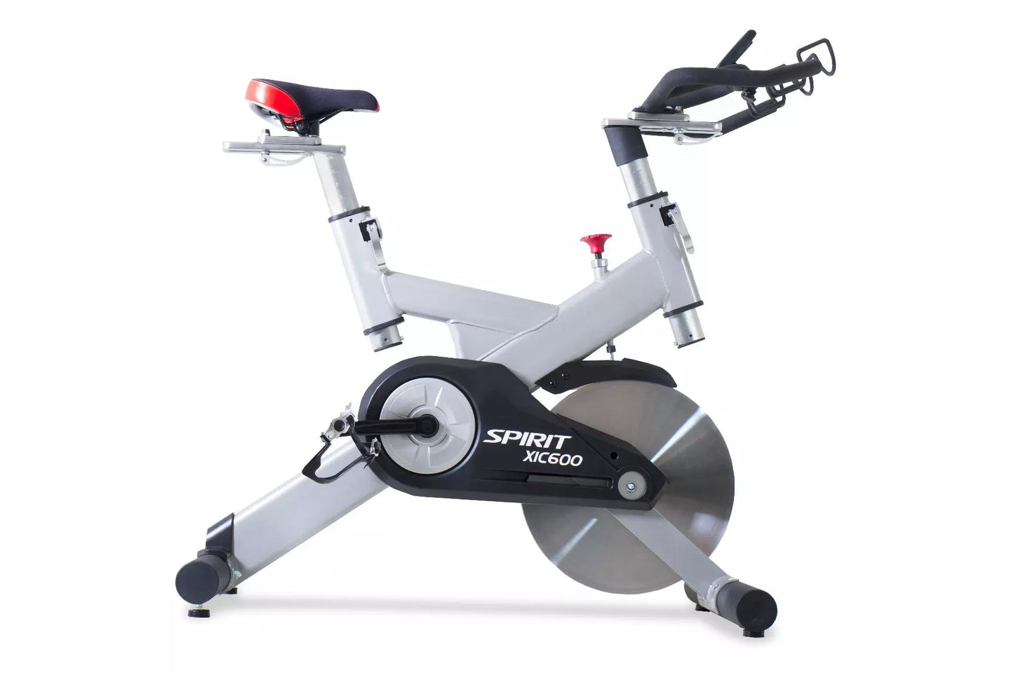 Spirit XIC600 indoor cycle with white frame, black flywheel, red seat and handlebars, on white background