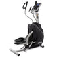 Spirit XS895 elliptical stepper trainer with black pedals, silver frame, digital console, and hand grips on white background