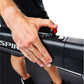 Man's hand gripping black treadmill handlebar with red button, demonstrating grip on Spirit XT485 treadmill