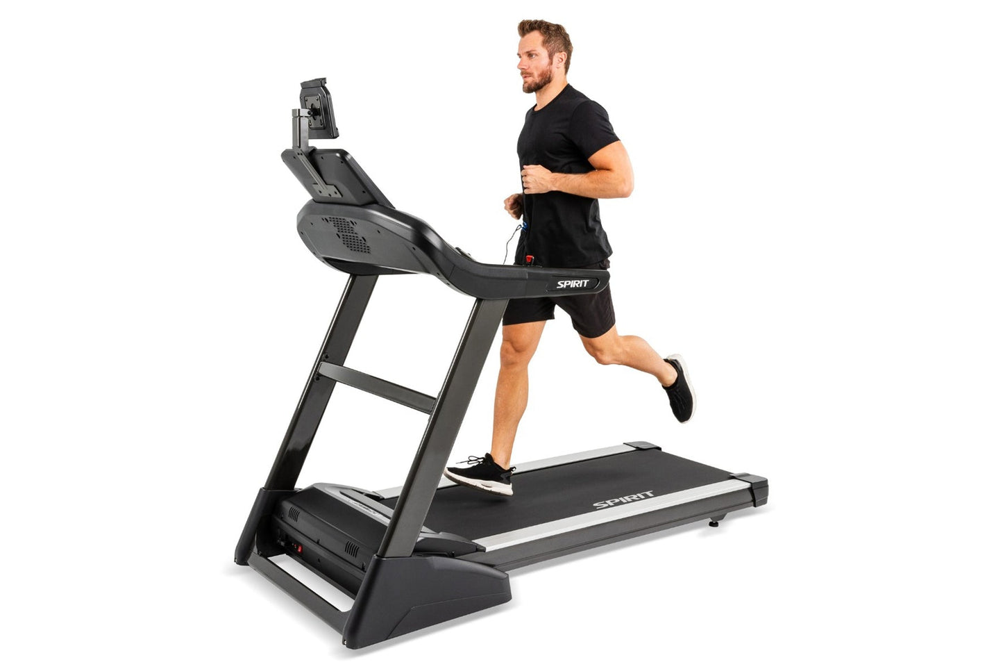 Man in black shirt and shorts running on Spirit XT485 treadmill with digital display, white accent stripe on black running de