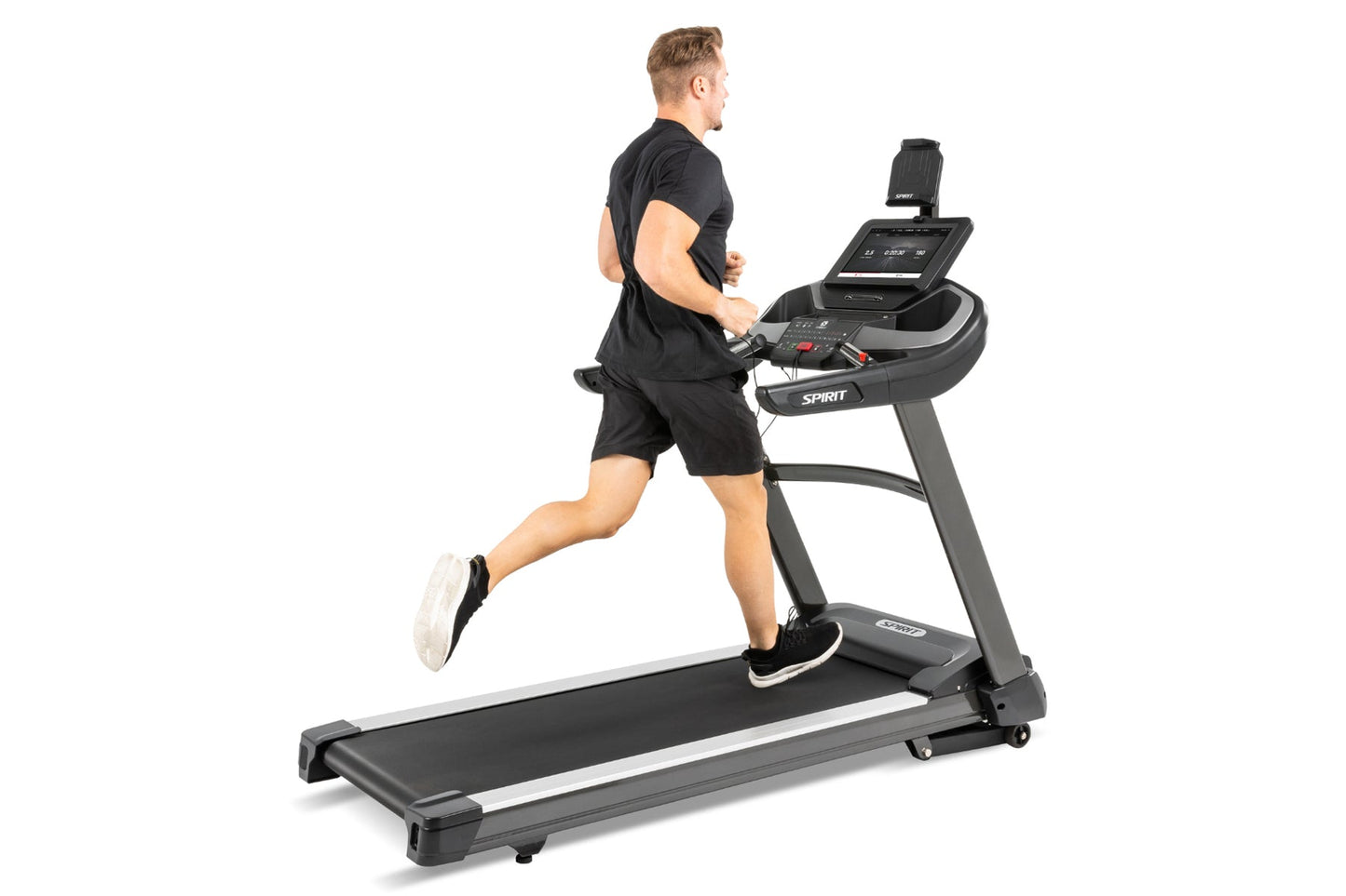 Man in black athletic wear running on Spirit XT685ENT treadmill with digital display, against white background