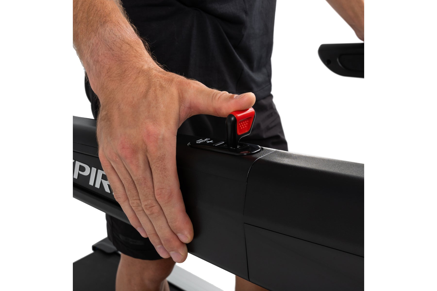 Man's hand operating red start button on black Spirit XT685ENT treadmill console