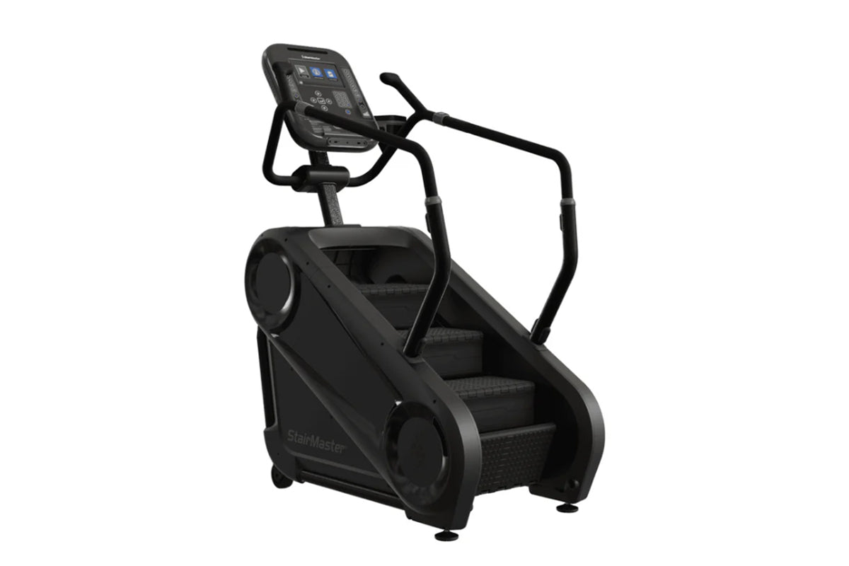 Black StairMaster Gauntlet 4G StepMill with digital console, handrails, and stepped climbing surface on white background