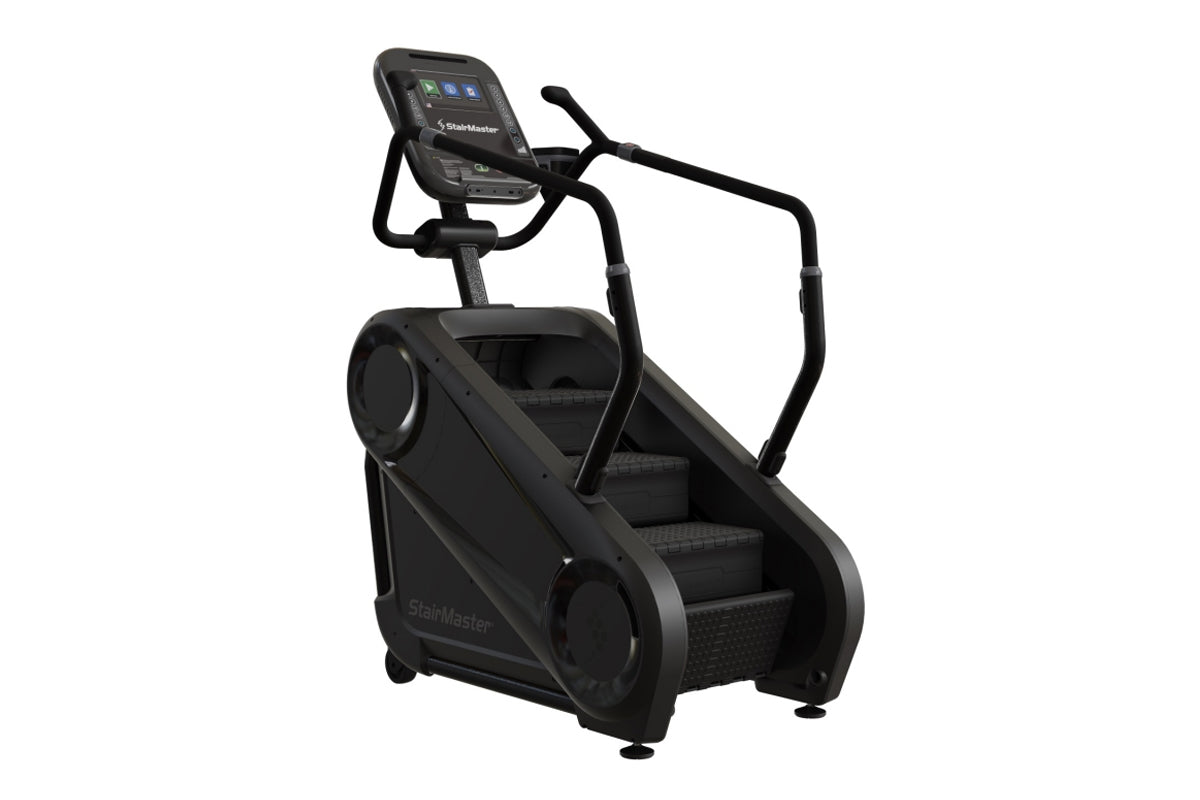 Black StairMaster Gauntlet 4G StepMill with digital display console, handrails, and stepped platform on white background