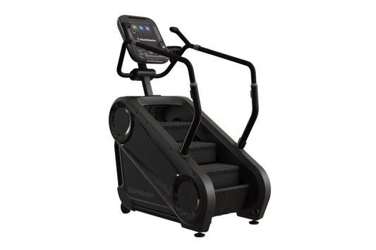 Black StairMaster Gauntlet 4G StepMill with digital display console, handrails, and stepped platform on white background