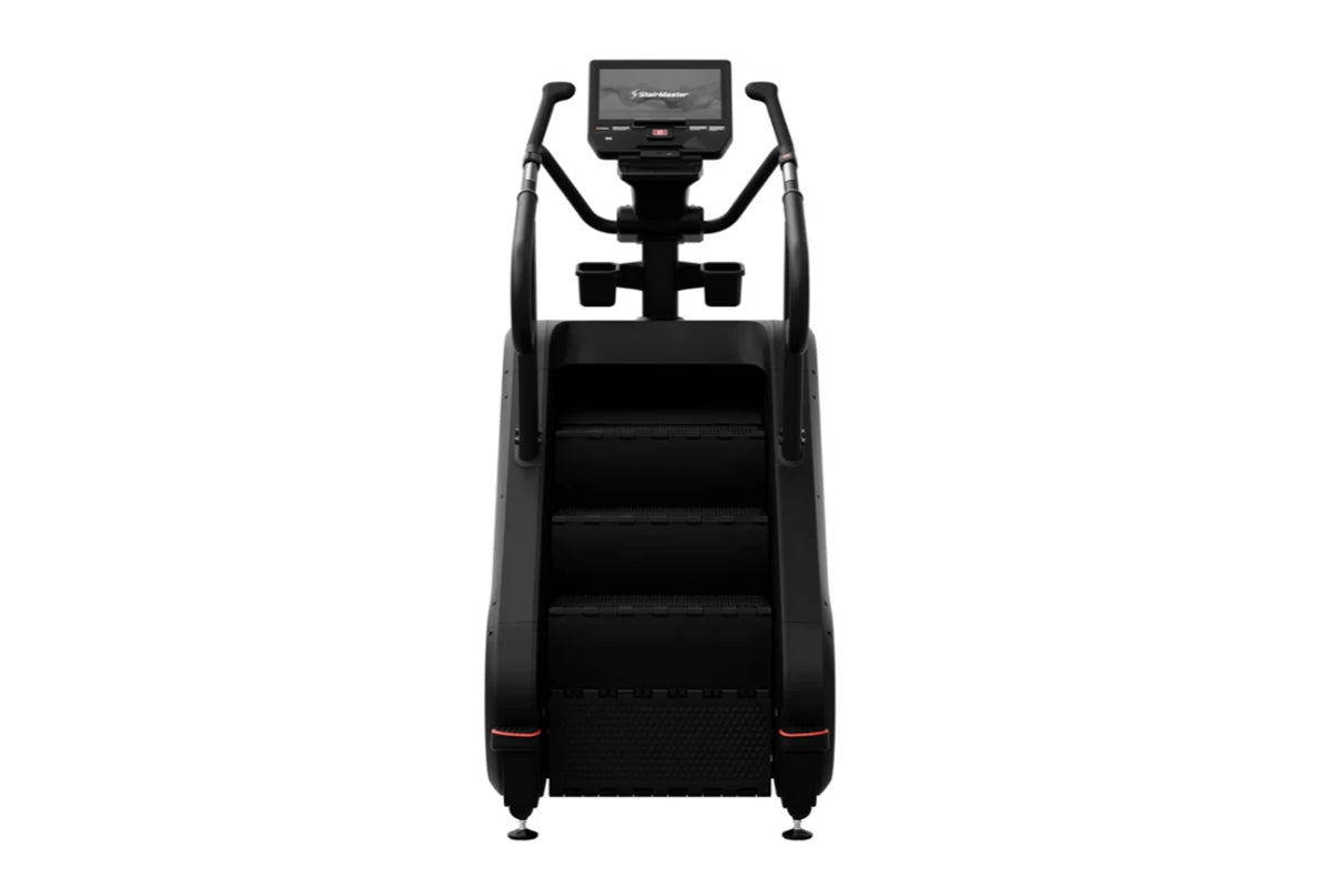 Black StairMaster 8Gx Gauntlet stair stepper with digital display console, dual handles, and wide stepped platform on white b