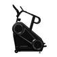 Black StairMaster 8Gx Gauntlet stair stepper with dual foot pedals, handlebar grips, and digital display on white background