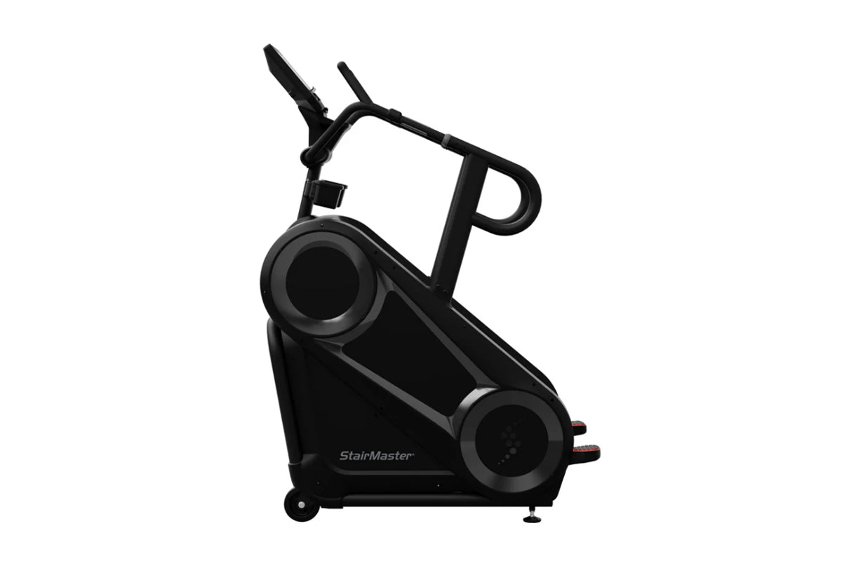 Black StairMaster 8Gx Gauntlet stair stepper with dual foot pedals, handlebar grips, and digital display on white background