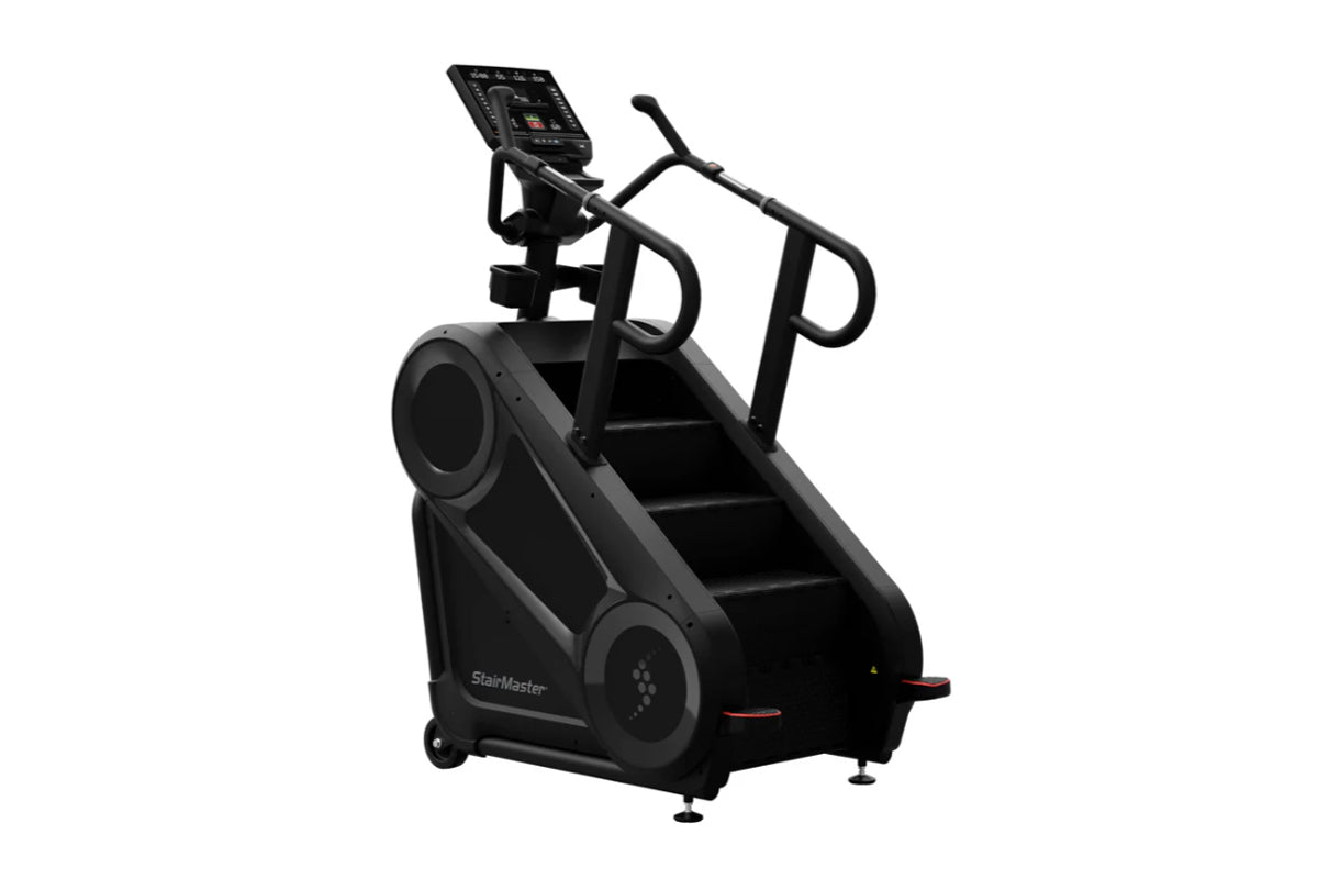 Black StairMaster 8Gx Gauntlet stair stepper with digital console, handrails, and wide steps on white background