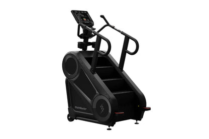Black StairMaster 8Gx Gauntlet stair stepper with digital console, handrails, and wide steps on white background