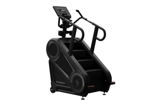 Black StairMaster 8Gx Gauntlet stair stepper with digital display, handrails, and stepped platform on white background
