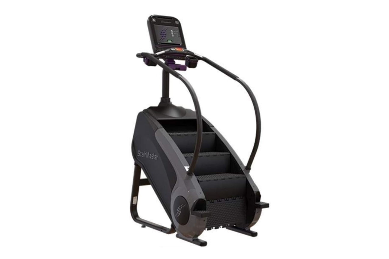 Black StairMaster Gauntlet 8G StepMill with digital display console, handrails, and stepped climbing surface on white backgro