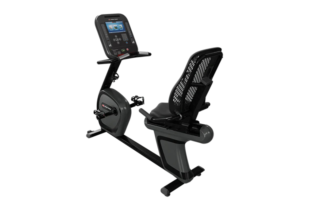 Black recumbent exercise bike with mesh back support, digital console with blue screen, and pedals, shown on white background