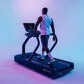Athlete wearing gradient pink and blue tank top and colorful sneakers running on black Star Trac treadmill with digital displ