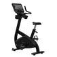 Black upright exercise bike with digital display console, padded seat, handlebars, and foot pedals on white background