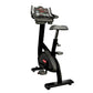 Star Trac SUBx upright exercise bike with black frame, gray seat, and digital console on white background