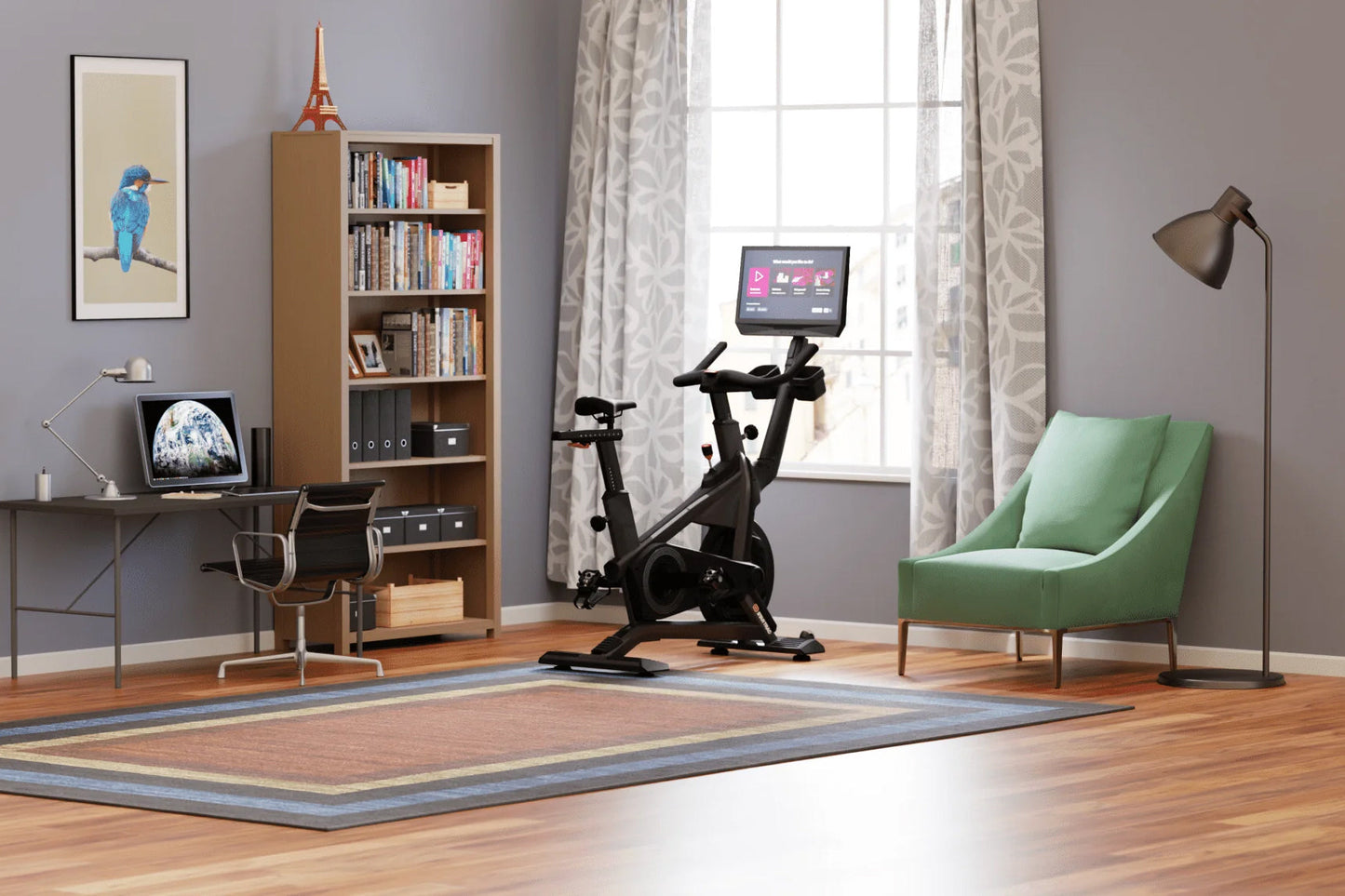 Black stationary exercise bike with digital display screen mounted on top, positioned in home gym setting