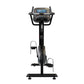 Black upright stationary bike with digital console display, handlebars, pedals with foot straps, and stable base on white bac