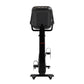 Black upright stationary exercise bike with digital display console, handlebars, pedals, and stable base on white background