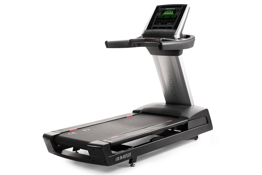 Black and silver motorized treadmill with digital display console showing green metrics, angled handrails, and cushioned runn