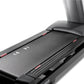 Black treadmill with gray textured running deck, side rails, and red accent details on white background