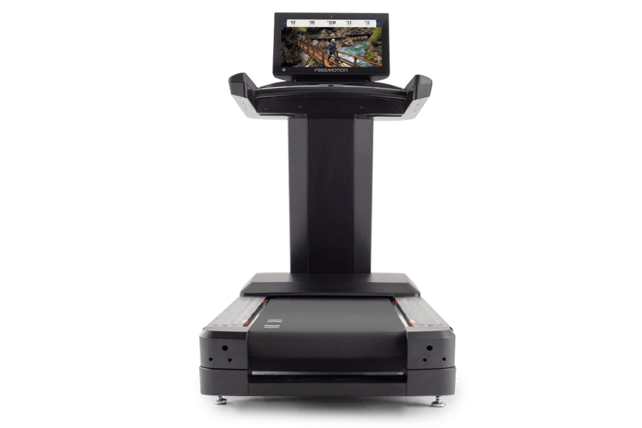 Black Freemotion t22.9 REFLEX treadmill with digital touchscreen display mounted on elevated stand, front view on white backg