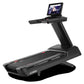 Black Freemotion t22.9 REFLEX treadmill with wide running deck, upright console displaying workout screen, on white backgroun