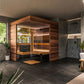 Thermasol Astra indoor sauna with warm wood exterior, glass doors, and bench seating in modern bathroom setting