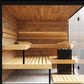 Thermasol Lumaria indoor sauna with tiered wooden benches, wood paneled walls and ceiling, glass door, and black heater unit