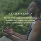 Man in meditation pose wearing dark tank top outdoors with blurred green background, with "Clear Your Mind" text overlay