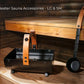 Electric sauna heater accessories set with wooden control panel, black metal bucket with wooden handles, and metal ladle on w