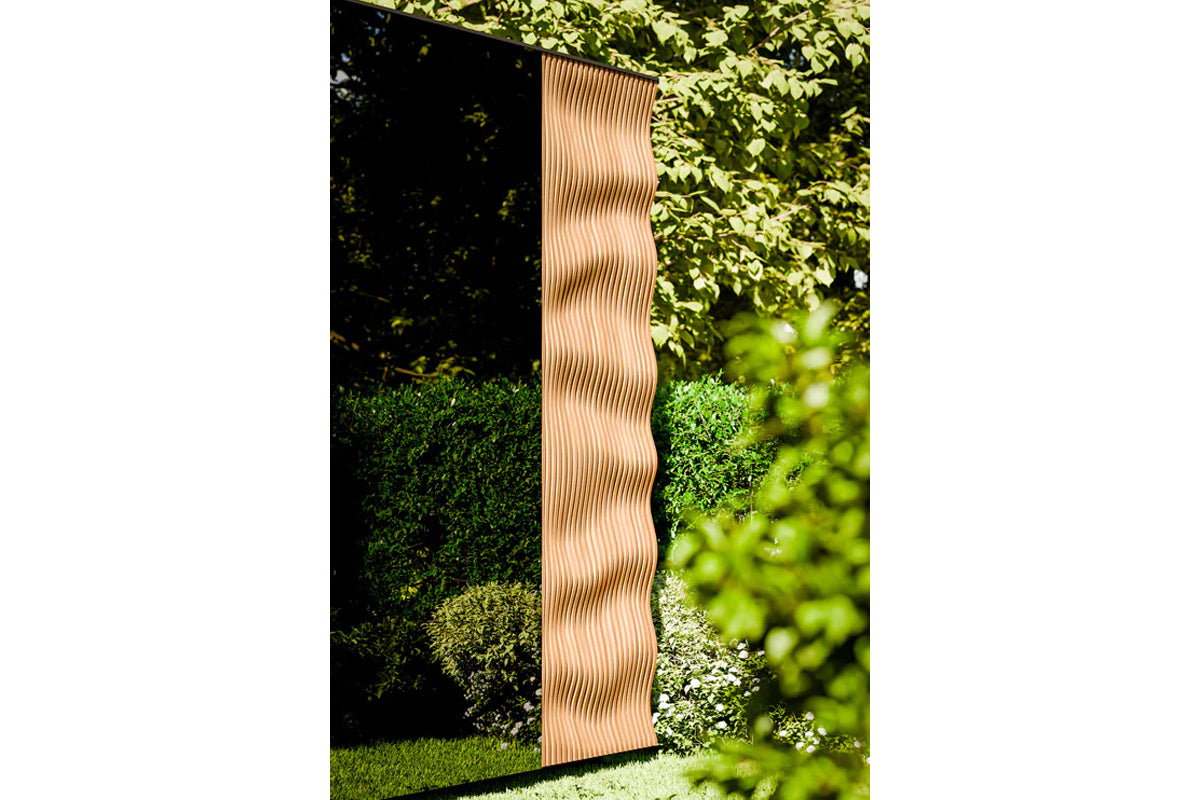 Thermasol Ombra outdoor sauna with natural wood vertical slat design in garden setting surrounded by green foliage