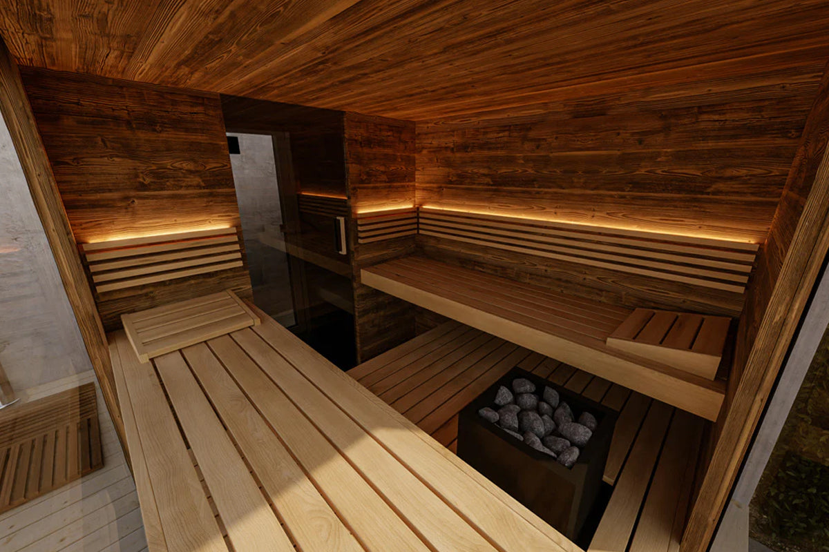 Interior view of wood sauna with built-in benches, black stove with heated rocks, and ambient lighting on white background