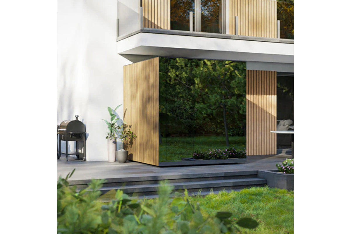 Modern wooden outdoor sauna with large glass doors and vertical slat cladding on contemporary patio