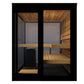 Black framed outdoor sauna with glass doors, cedar wood interior, benches, and heater visible on white background