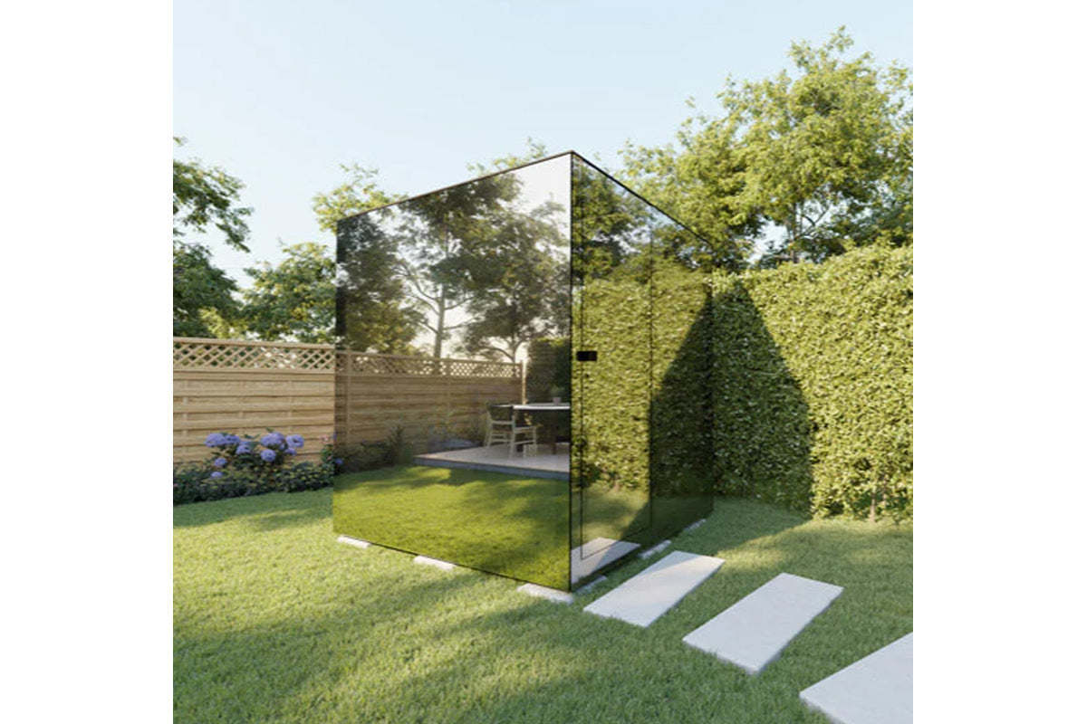Thermasol Vue outdoor sauna with black metal frame and glass panels in garden setting