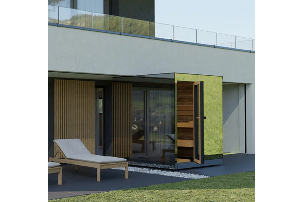 Modern outdoor sauna with lime-green moss wall panel, wood slat accents, open wooden door, and adjacent wooden lounge chair o